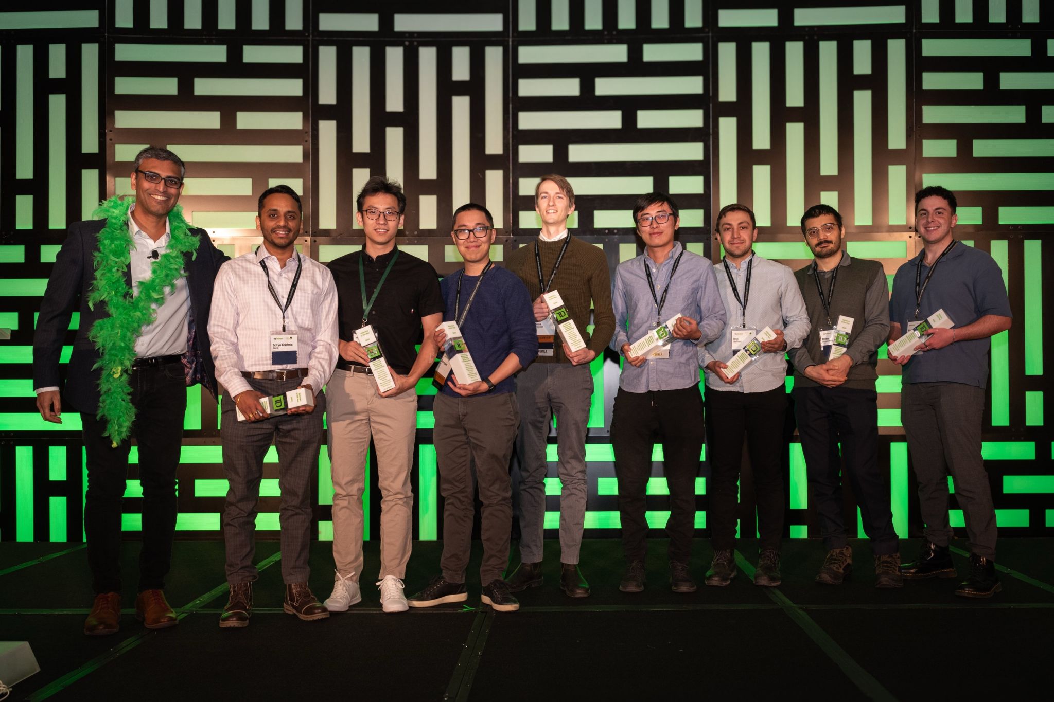 Group of TD Bank employees on stage holding innovation recognition awards at the Patent Inventor Celebration, celebrating creativity, boldness, and impact.